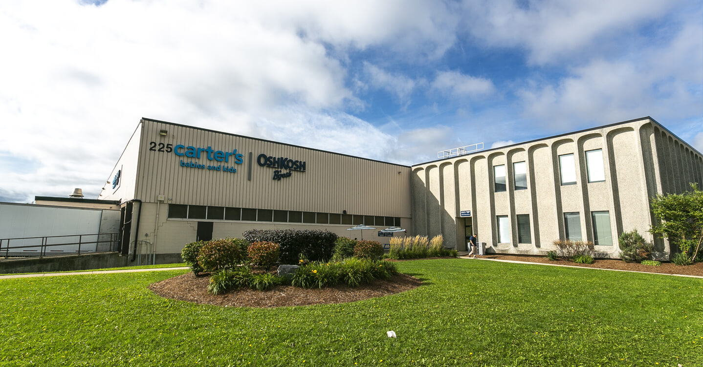 Industrial building with greenery in front of it