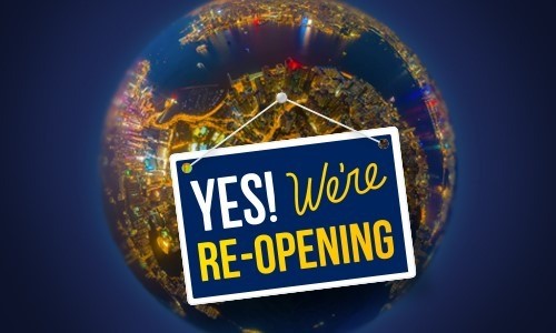 Plate with the word Yes We're re-opening on the background of the planet Earth