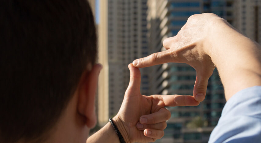 A person framing a view by their hands