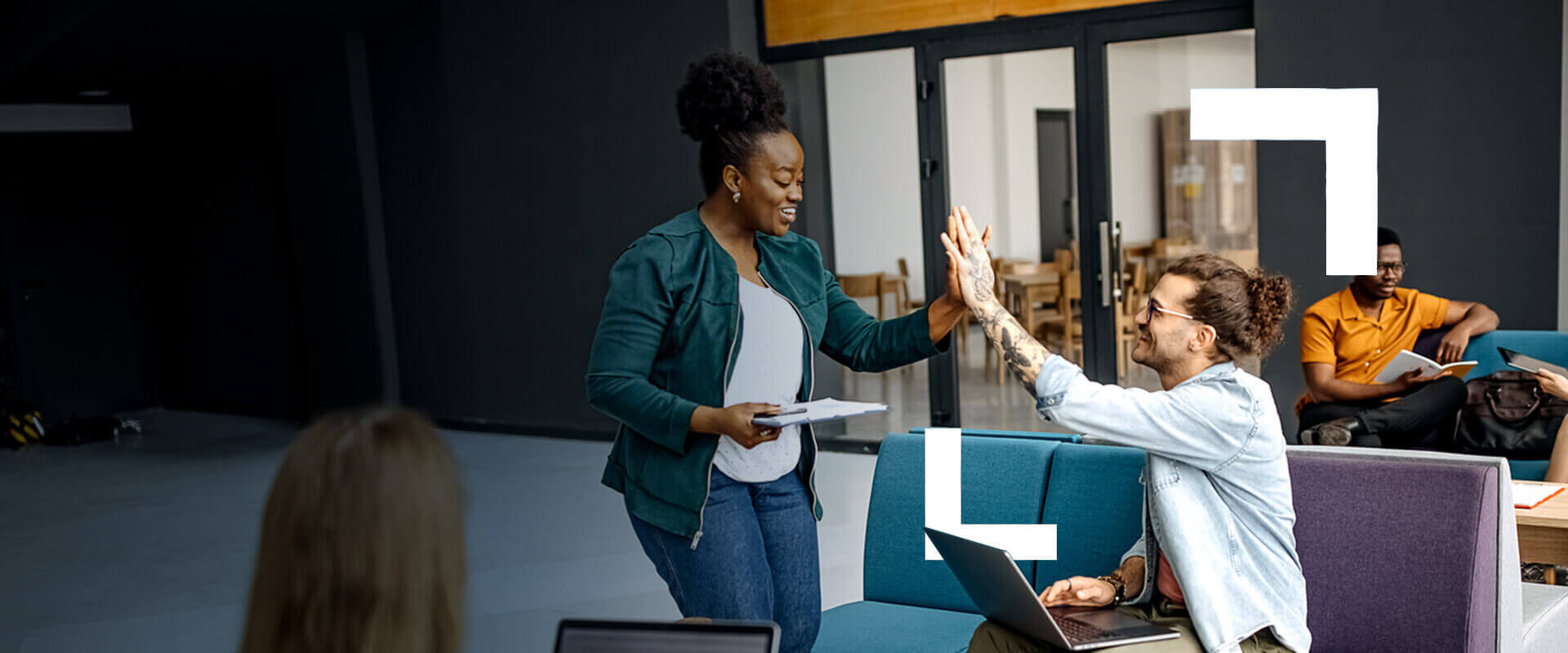 Co-workers give each other a high five