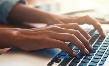 Closeup of laptop keyboard hands