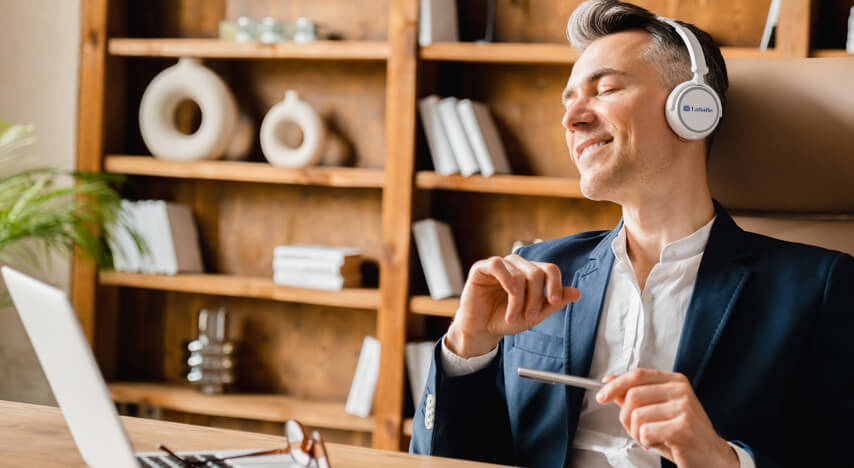 Smiling man listening to music with headphones