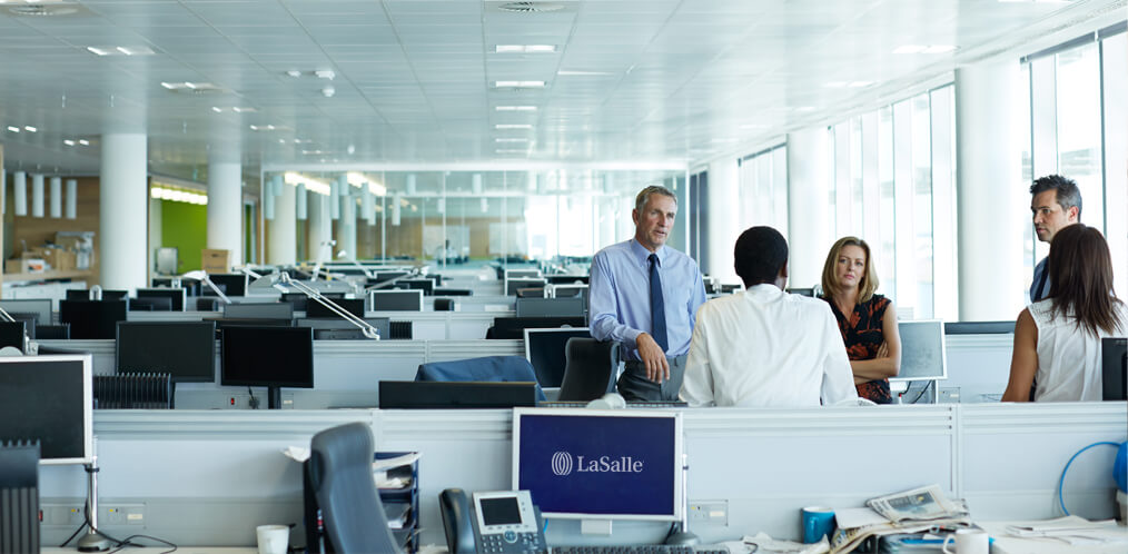 Employees talking in an open space office