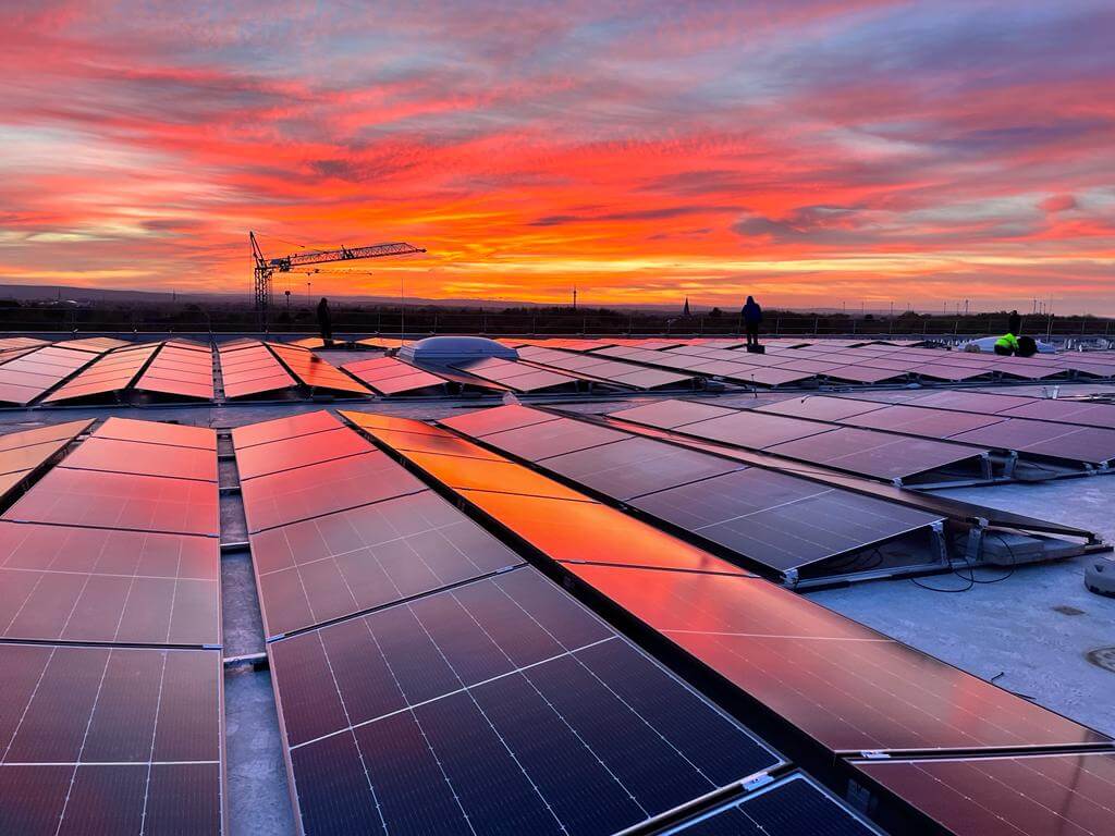 View on the rooftop with solar panels during sunset