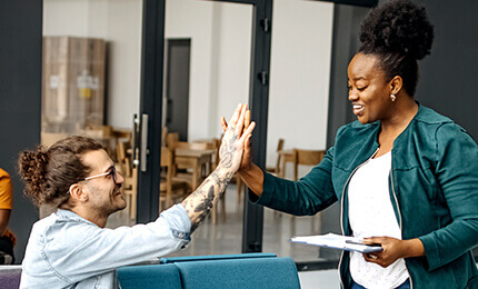 Co-workers giving each other high fives