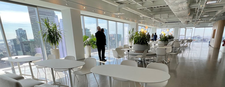 Room filled with white tables and chairs