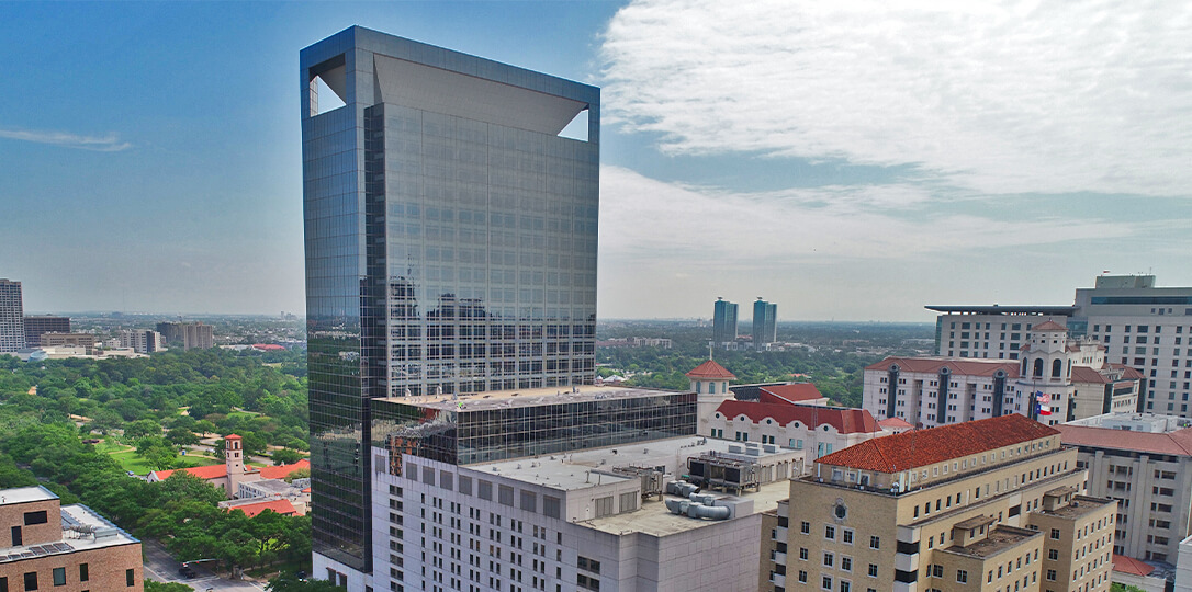 A skyscraper and a park in the background