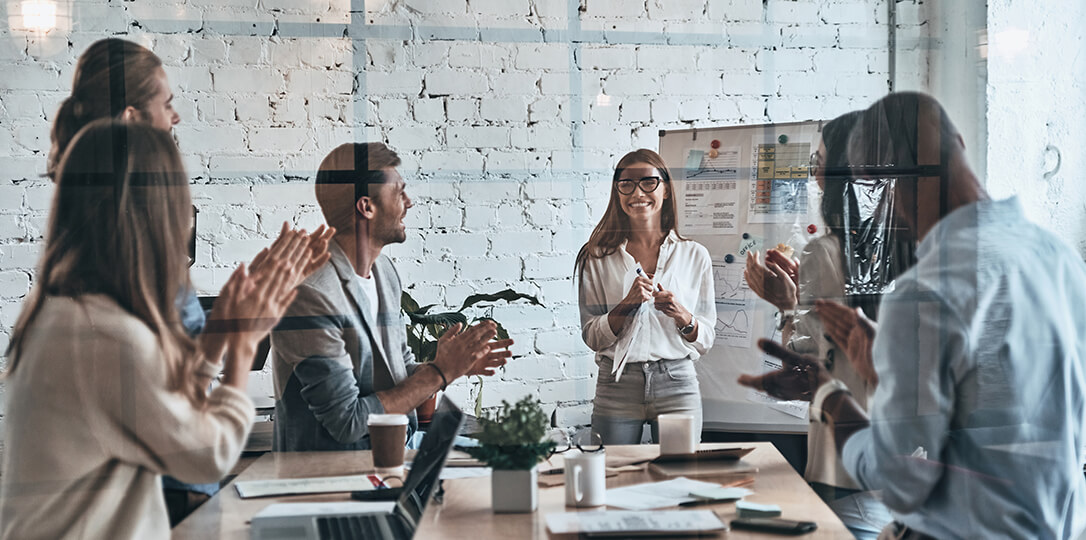 People in the office applauding a woman