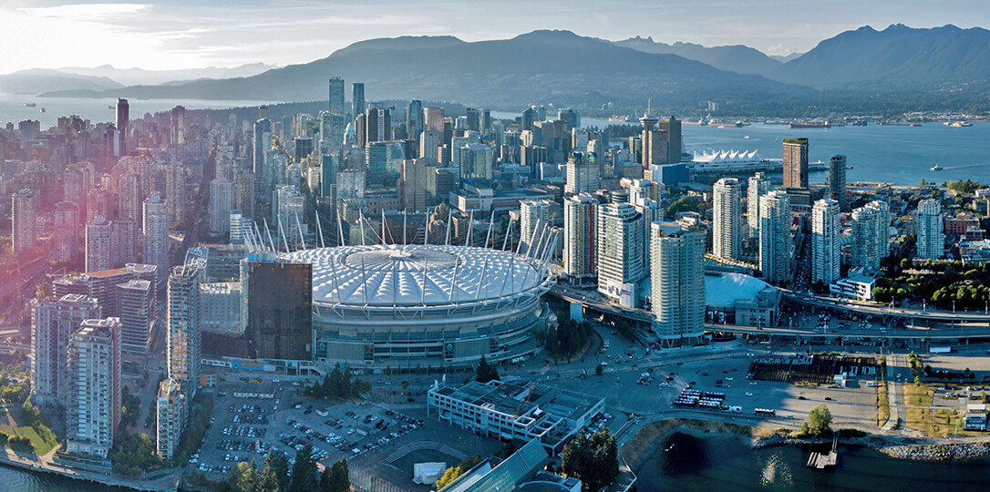 A soccer stadium in the middle of a modern city