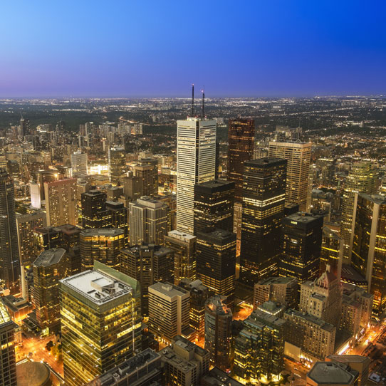 Illuminated city and skyscrapers at night
