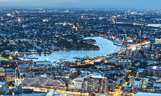 Illuminated city by the bay at night