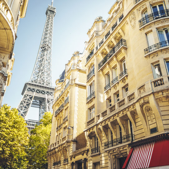 Yellow building with the Eiffel Tower on the background