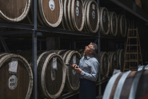 A man counting barrels.