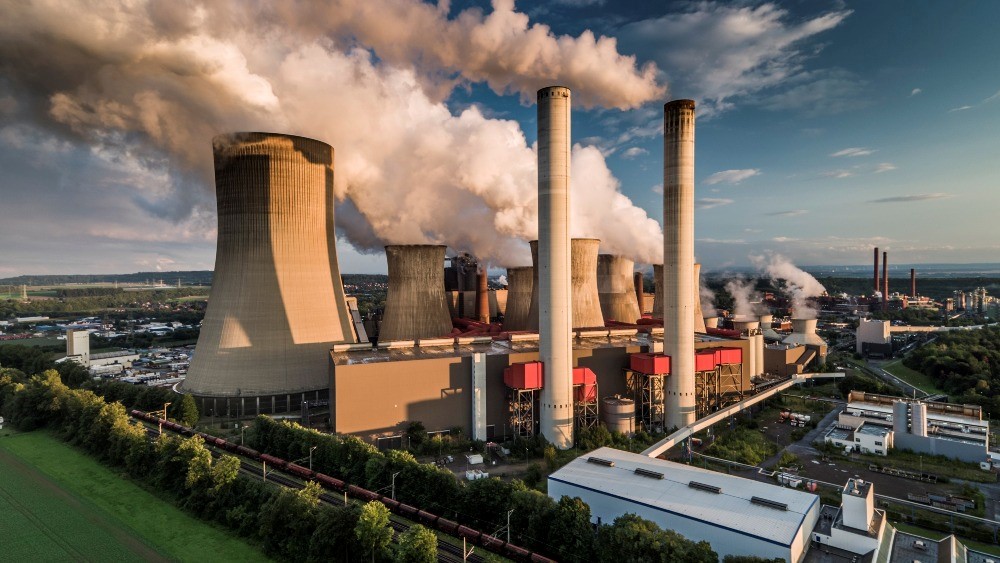 Power plant with huge chimneys from which smoke comes out