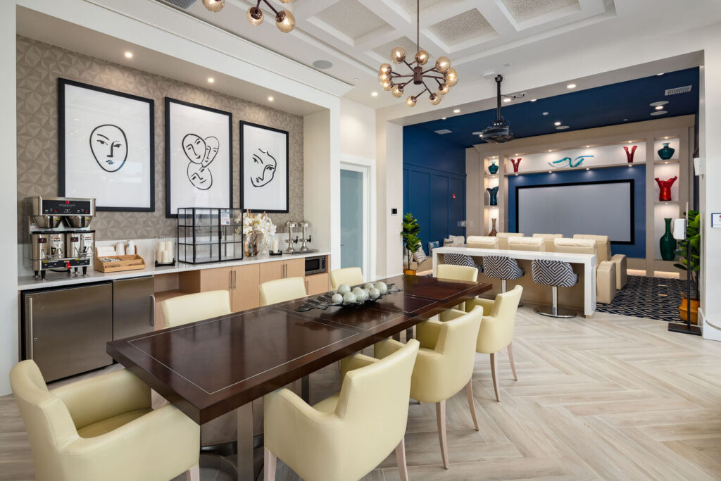 A designer buffet with an espresso machine and pictures on the wall.