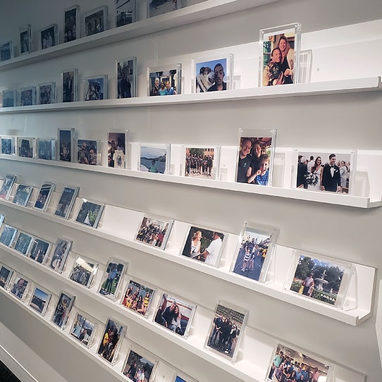 A wall with photos of important moments in the lives of employees