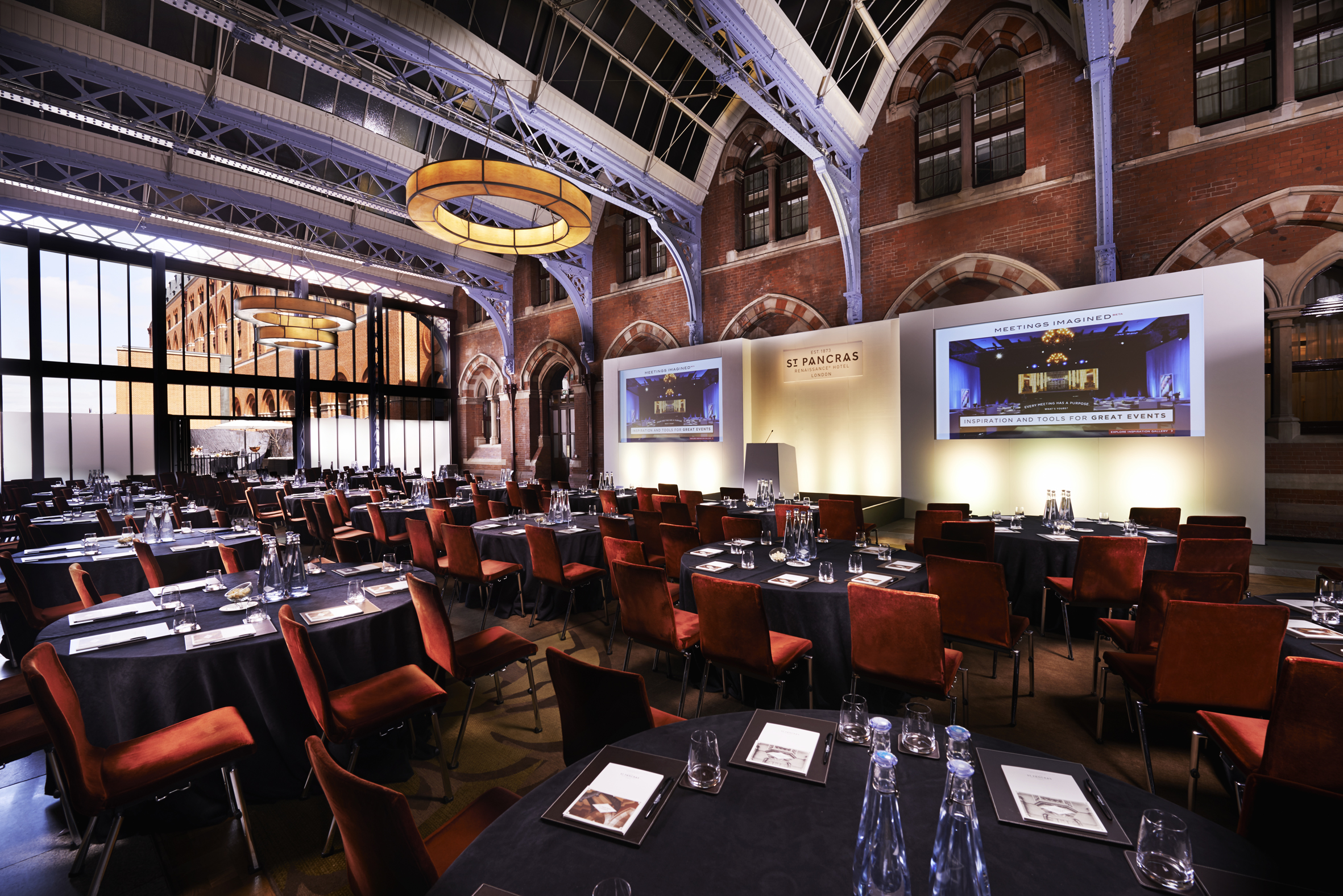 The Hansom Hall at St Pancras Renaissance Hotel, featuring a grand vaulted ceiling, modern lighting, and event setup with tables and chairs.